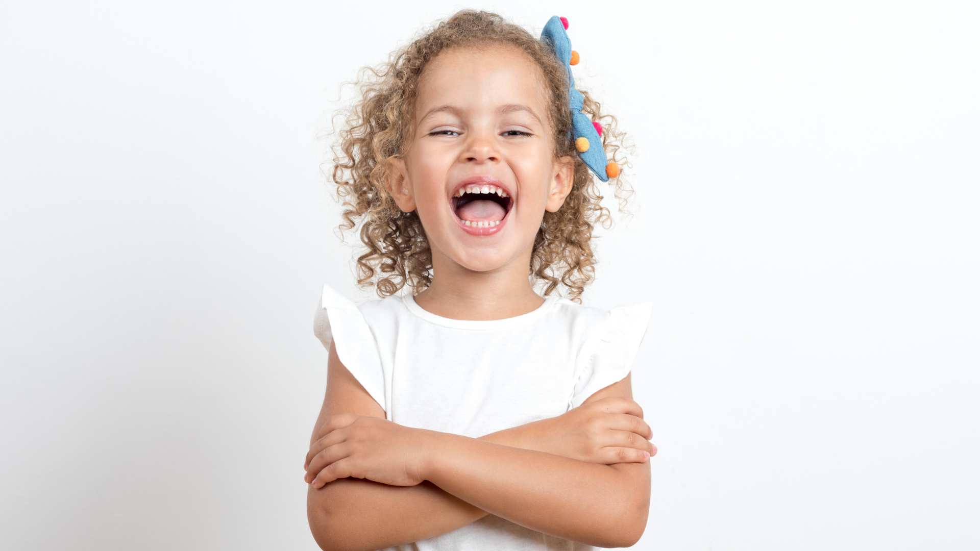 A happy child laughing, supporting a message about recognizing autism in girls