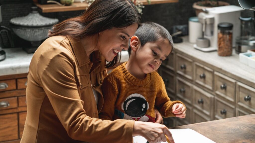A mom happily directs her child through ADOS-2 Autism Assessment testing.