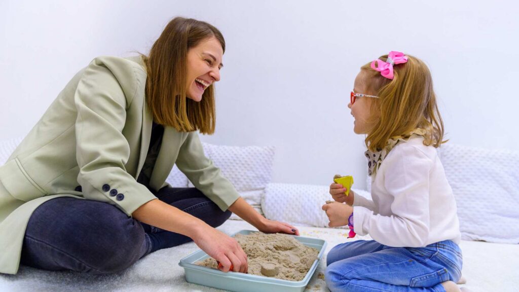 An ABA professional and a toddler in guided play. This works well for topics about when a toddler doesn’t respond to their name and how early intervention can encourage growth.
