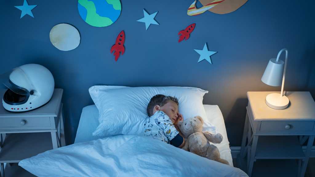 Child with autism sleeping in a calm bedroom, representing autism and sleep disturbance and common sleep disorders.