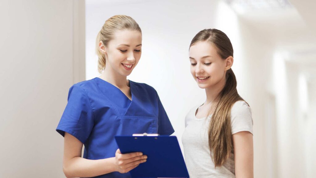 Professional applying an autism assessment to young girl