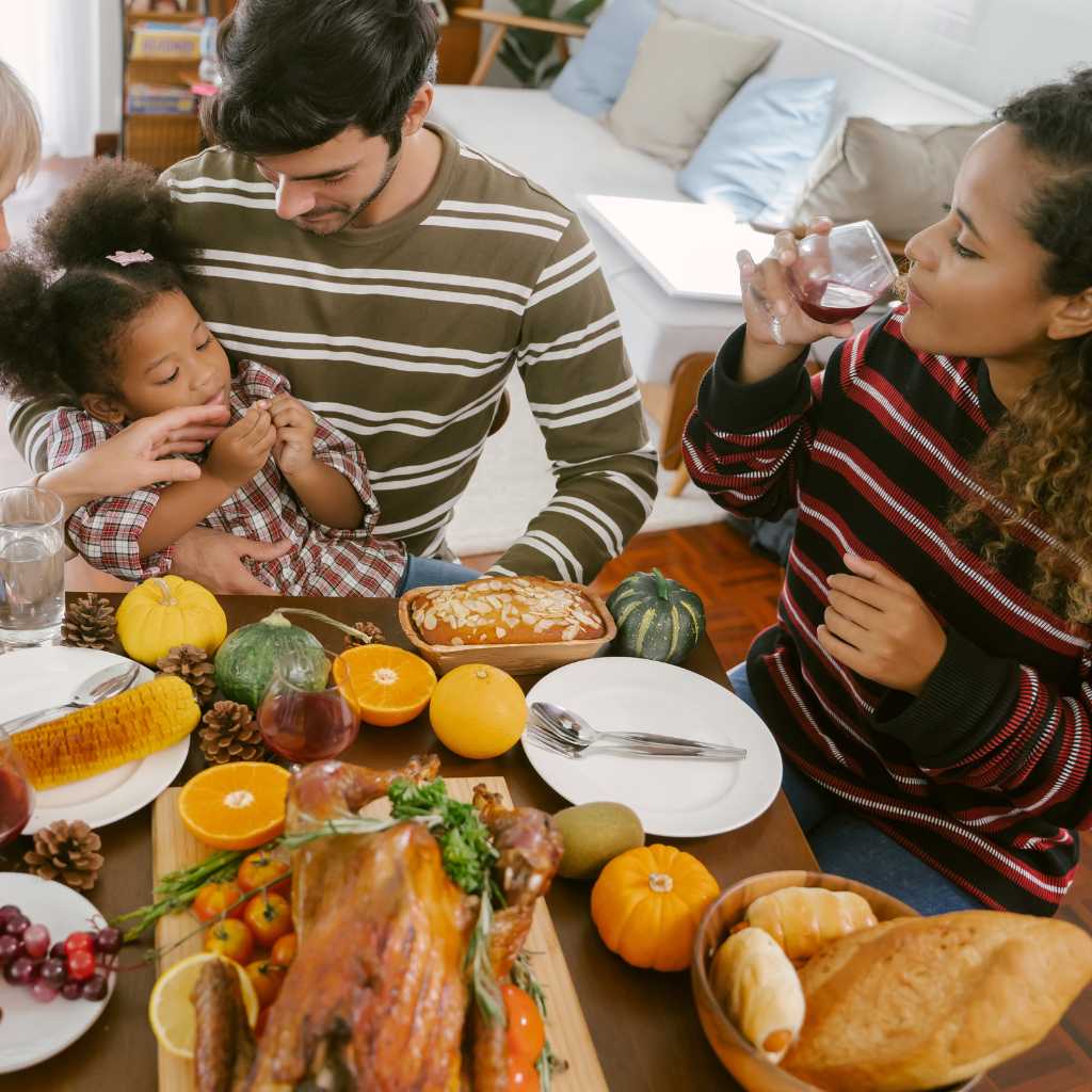 Family enjoying Thanksgiving meal together, emphasizing inclusion and connection over perfection during holidays with autism.