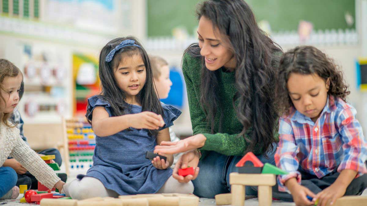Blog 6 A Board Certified Behavior Analyst works with children as they play with blocks