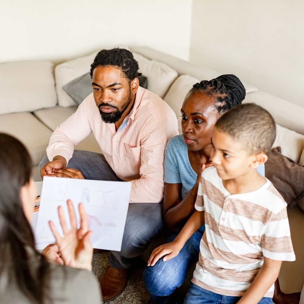 Parents and child meeting with a professional to discuss developmental support with ABA therapy for preschoolers