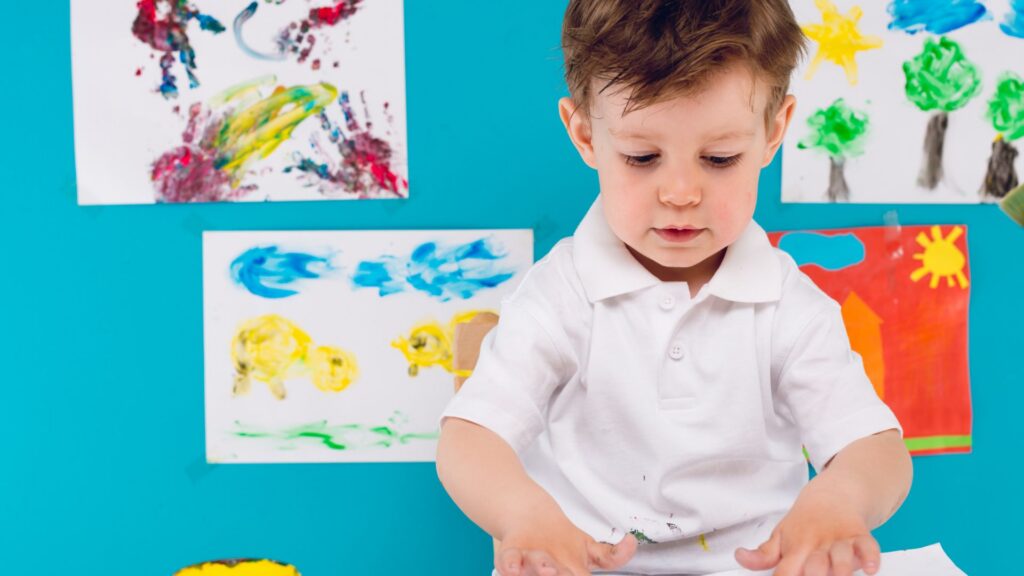 Preschool-aged child participating in a colorful creative activity from ABA therapy for preschoolers