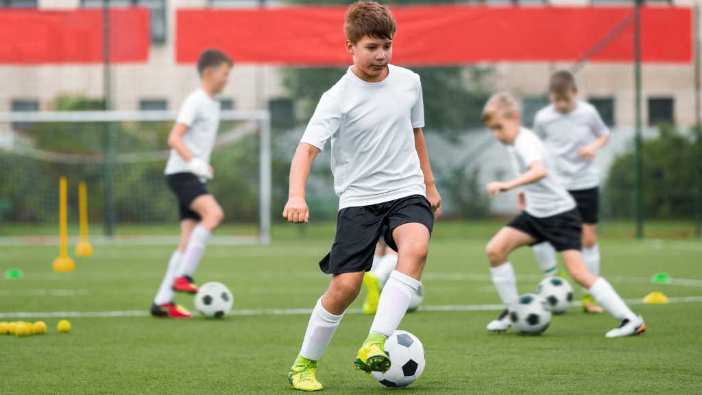 Soccer practice demonstrating sports for children with autism and teamwork skills